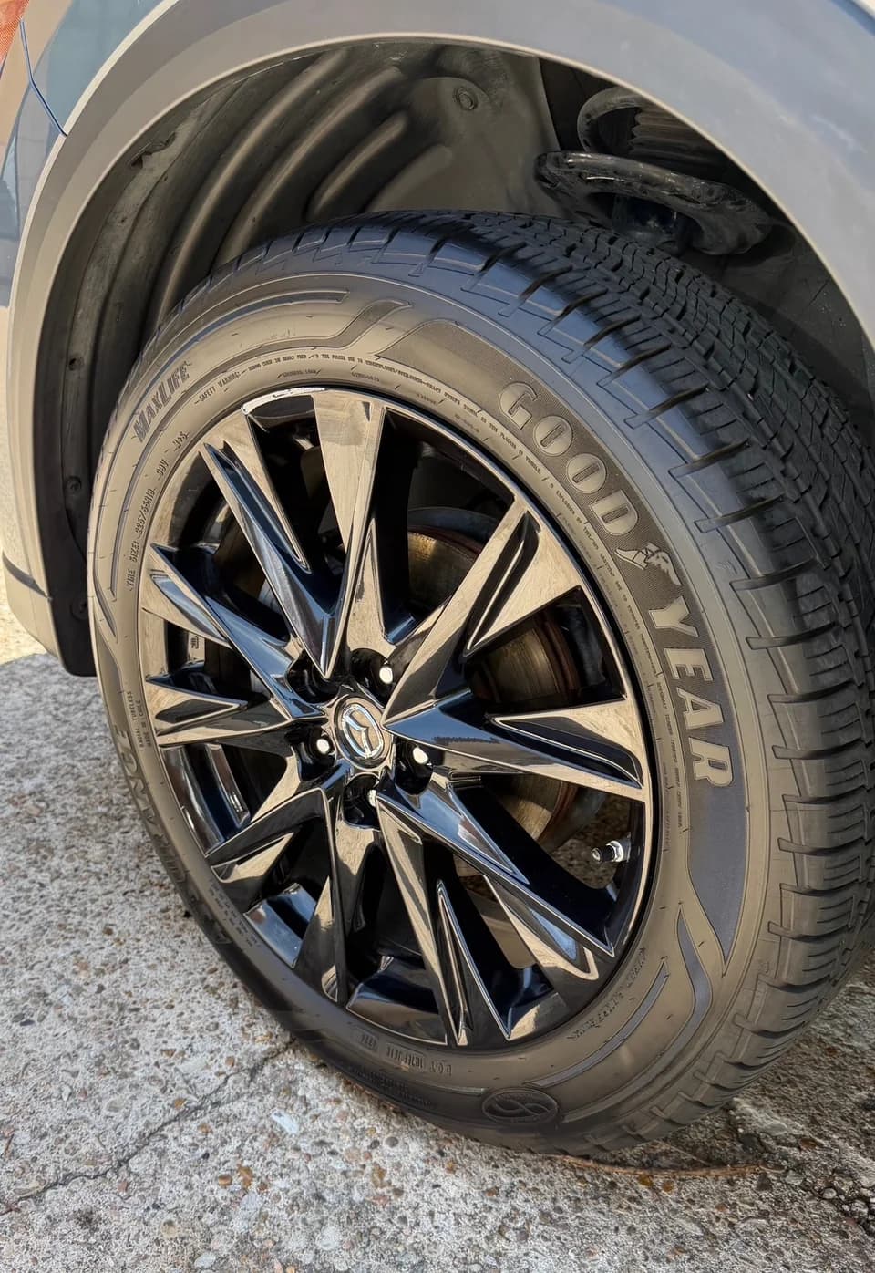 Black Mazda alloy wheel and tire viewed close up